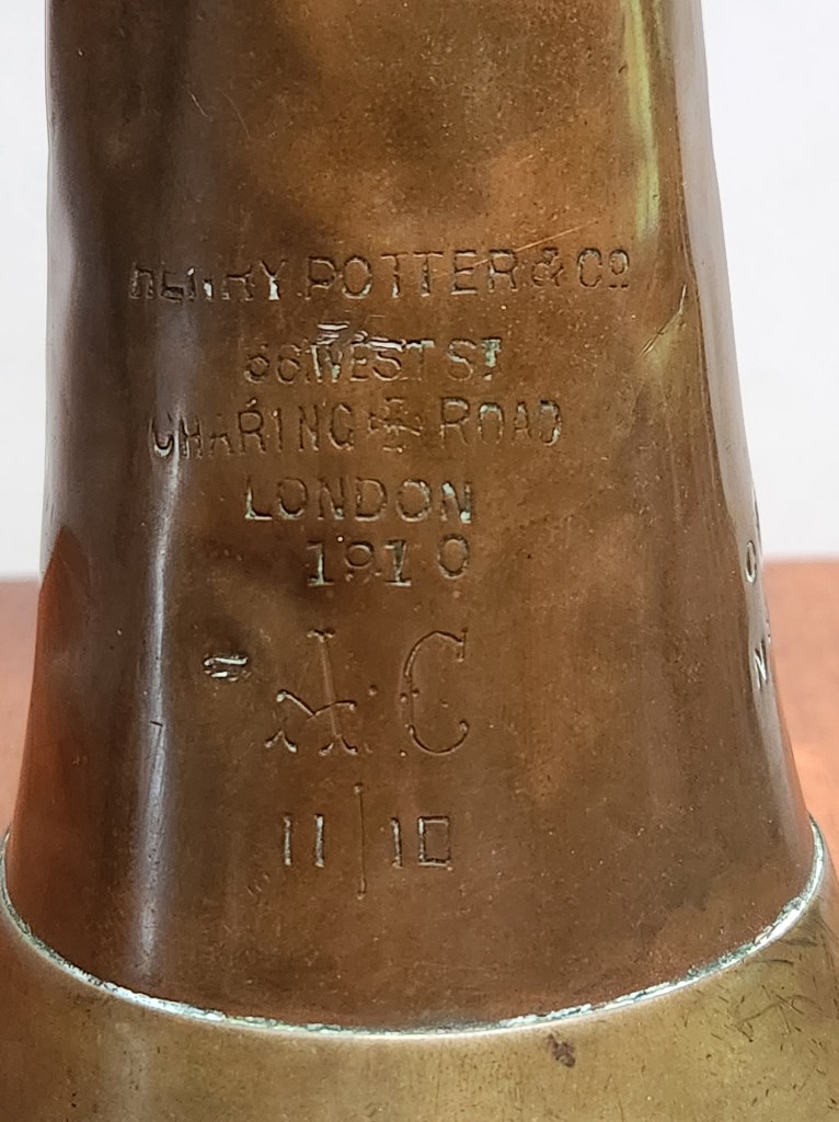 Photograph of the maker's mark on a bugle used in World War One